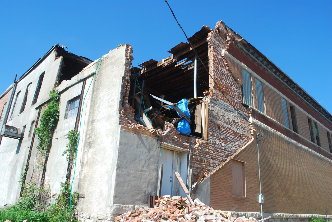 Forensic documentation of a storm-related masonry building collapse, wide elevation view